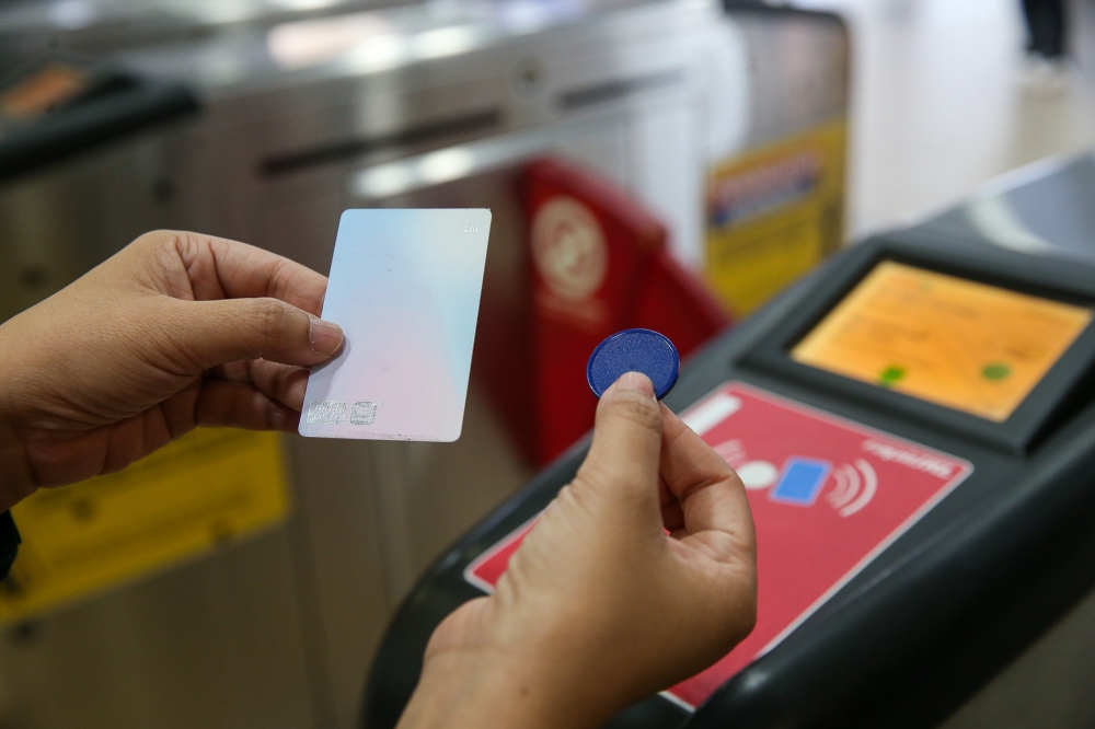 Will you be using a token or a Touch 'n Go card to ride the trains in Kuala Lumpur? — Picture by Choo Choy May .