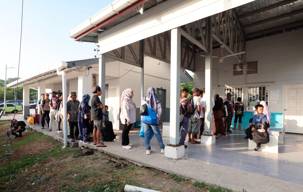 People queue up to get tickets to board the ferry from Pulau Banggi’s Karakit Jetty to the mainland. Kudat Town is located an hour and a half ferry ride from Pulau Banggi. The ferry fare from Pulau Banggi to Kudat costs RM26 one way, bringing the total return trip to RM52, a significant amount for low-income island residents. — Bernama pic