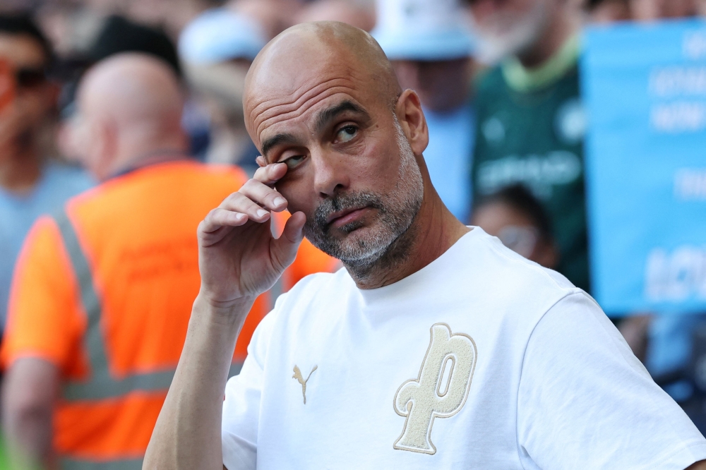 Manchester City’s Spanish manager Pep Guardiola reacts as he watches videos of himself during ceremonies to honour those leaving the club at the end of the season, following the English Premier League football match between Manchester City and Aston Villa at the Etihad Stadium in Manchester May 24, 2026. — AFP pic