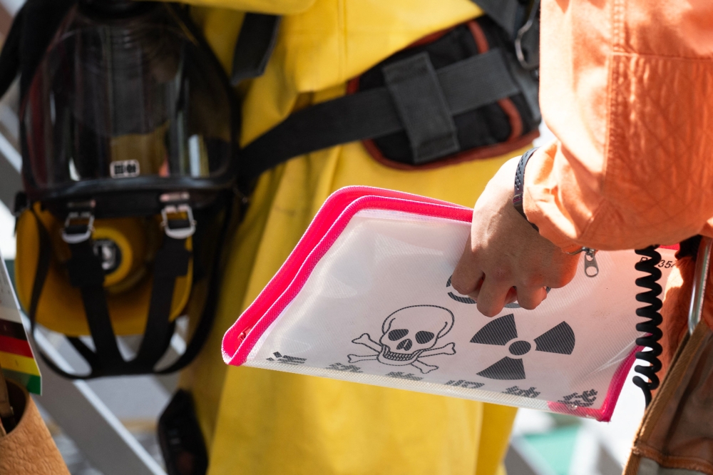 Emergency personnel hold a HAZMAT folder outside the Ginza 6 Shopping Center in Tokyo on May 25, 2026, after an individual allegedly sprayed a substance in the area. — AFP pic 
