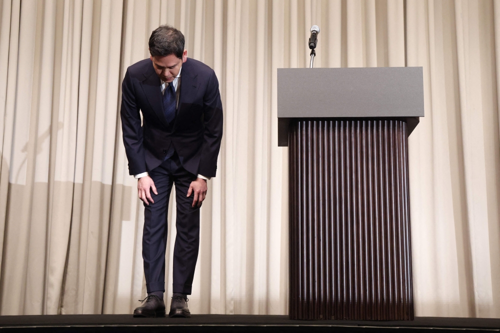 Chung Yong-jin, chairman of Shinsegae Group which operates Starbucks Korea, bows in apology during a press conference in Seoul on May 26, 2026. — Yonhap/AFP pic