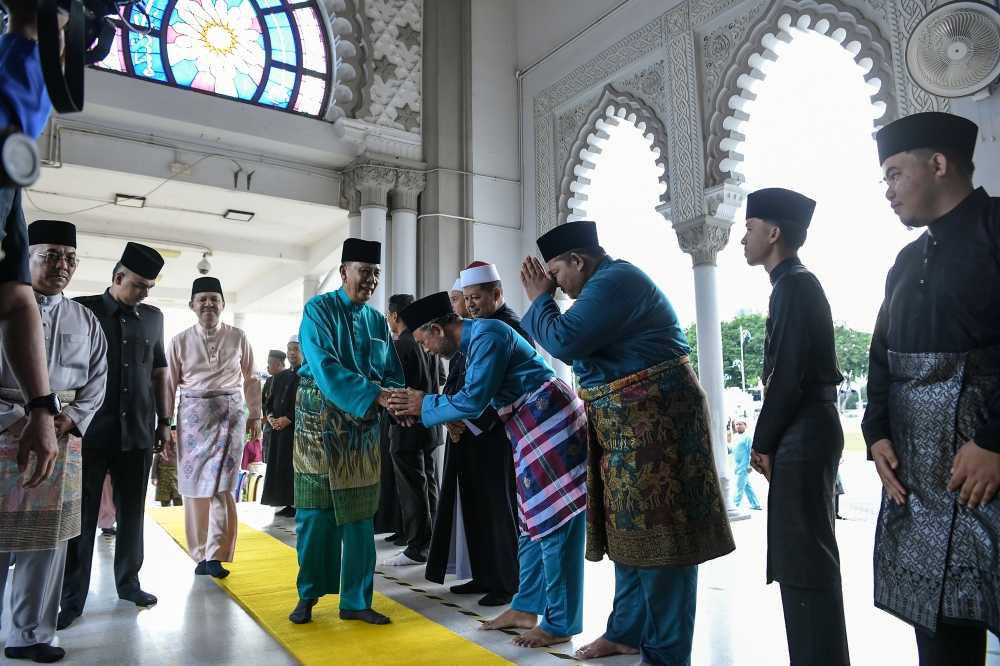 Sultan of Kedah Al-Aminul Karim Sultan Sallehuddin Ibni Almarhum Sultan Badlishah greets members of the public upon arriving for Aidiladha prayers at Masjid Zahir today. — Bernama pic
