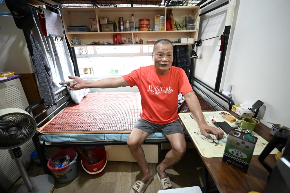 This photo taken on May 4, 2026 shows Chan Sai-chiu, 71, sitting in his new transitional housing unit in Kowloon, Hong Kong. — AFP pic