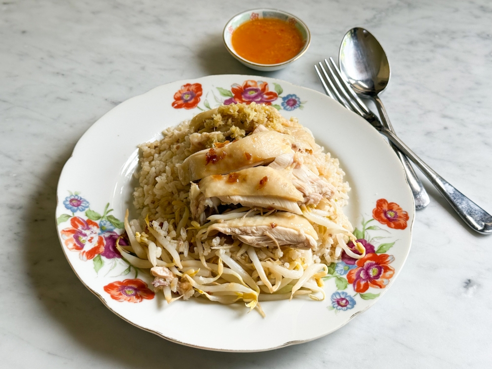 My takeaway chicken rice had soft, sticky rice with little flavour but the chicken thigh was very smooth. — Picture by Lee Khang Yi