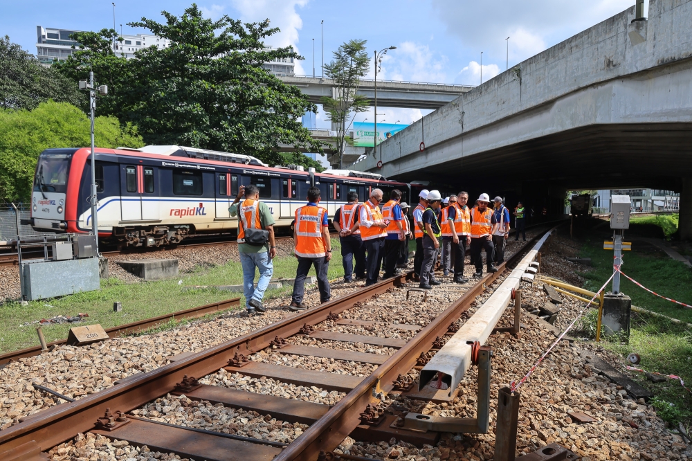 Transport Minister Anthony Loke and officials walk along the tracks at the site of a  Ampang/Sri Petaling Line train derailment near the Chan Sow Lin station in Kuala Lumpur on May 29, 2026. — Picture by Yusof Isa