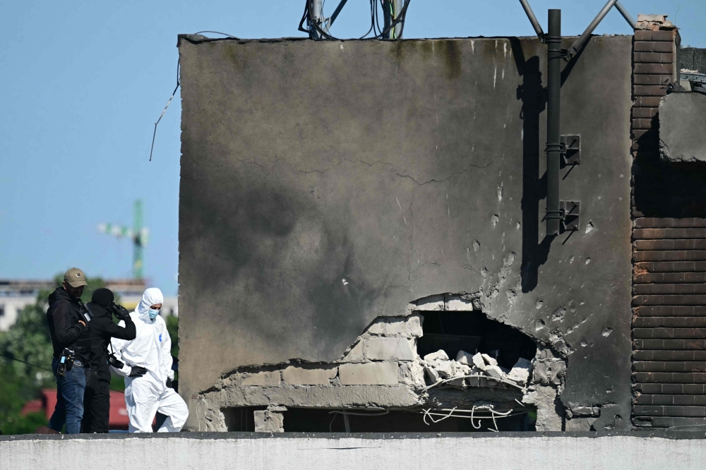 Police and forensic investigators examine the location of impact after a Russian drone struck an apartment building in Galati, western Romania on May 29, 2026. — AFP pic