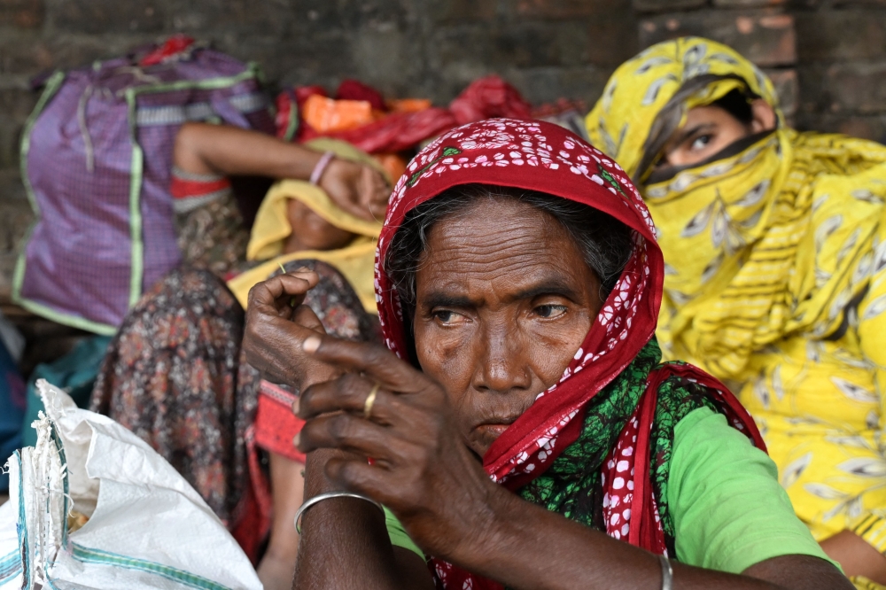Bangladeshi migrants who had allegedly illegally crossed border, arrive for verification near the Indian Border Security Force (BSF) camp on the outskirts of Kolkata on May 28, 2026. — AFP pic