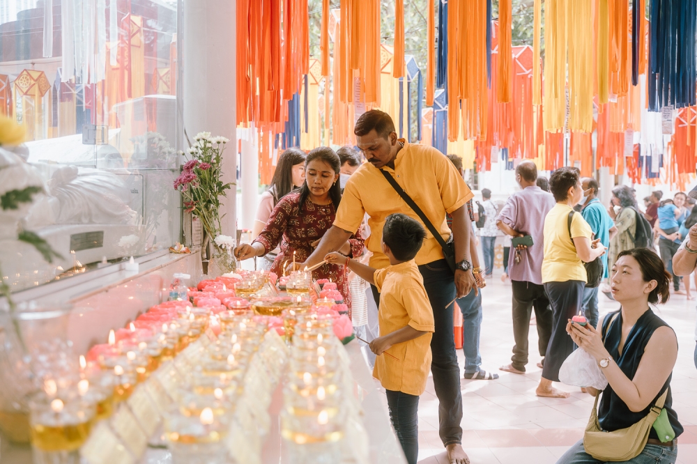 On Wesak Day, devotees light lotus candles, with the flower widely associated in Buddhism with purity, spiritual awakening and enlightenment. — Picture by Raymond Manuel