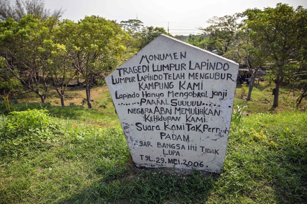 A memorial installed on the Lapindo mud embankment is pictured at the mud volcano area marking 20 years since a gas exploration accident triggered a mud flow that inundated more than a dozen villages and permanently displaced tens of thousands of people in Porong, Sidoarjo, East Java province on May 29, 2026. — AFP pic