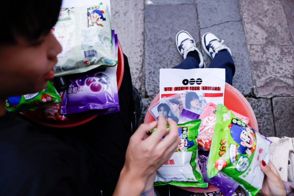 BTS fans prepare snacks, group merchandise, concert seat maps and wish lists to be placed on an altar table as they pray to Yue Lao, the god of love in Chinese mythology who oversees relationships and marriage, at Taipei’s Bangka Lungshan Temple, in hopes of securing a concert ticket, in Taipei, Taiwan, May 30, 2026. — Reuters pic