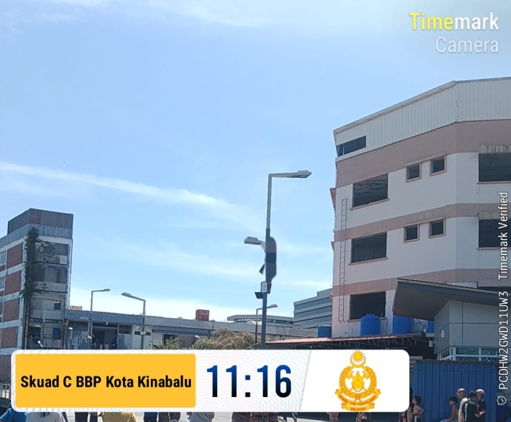 Emergency call sparks swift response as Kota Kinabalu firefighters rescue man from streetlight pole