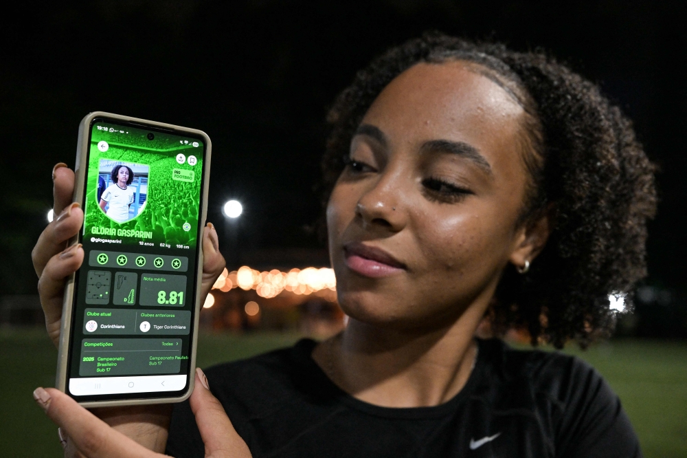 Brazilian football player Gloria Gasparini is seen on screen of the Foot Bao app, in Sao Paulo, Brazil, on May 5, 2026. — AFP pic