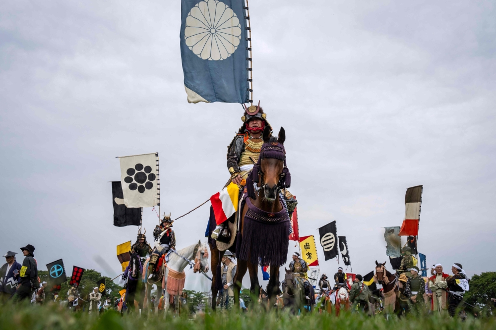 Horsemen clad in samurai armor attend a ceremony during the Soma Nomaoi festival at Hibarigahara field in Minamisoma, Fukushima prefecture on May 24, 2026. — AFP pic