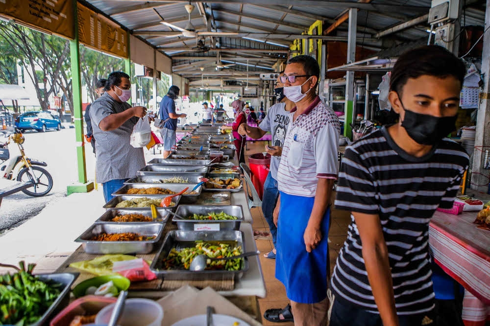 Nasi campur still a popular choice, some refer to it as the Malay cuisine of economy rice — Picture by Hari Anggara