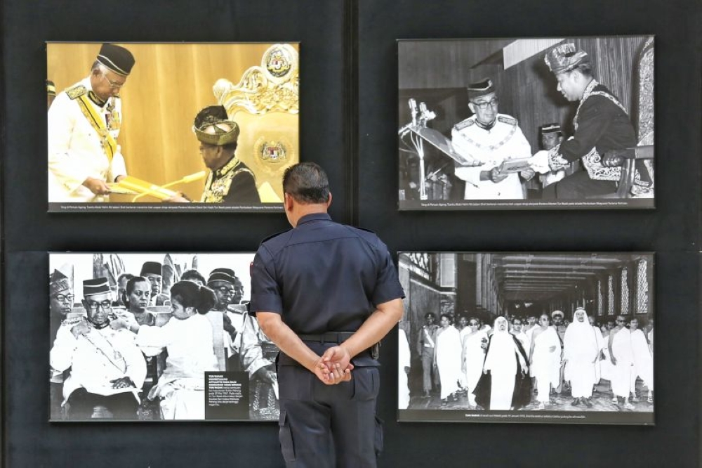 A policeman looks at pictures depicting Malaysia's second prime minister Tun Abdul Razak Hussein at a special commemorative seminar held at the Royale Chulan Hotel, Kuala Lumpur January 14, 2015. — Picture by Saw Siow Feng