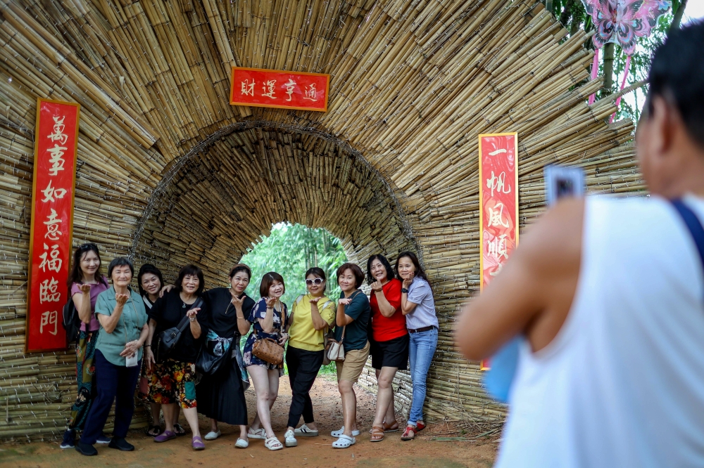 Visitors pose for pictures while enjoying the beautiful landscape and peaceful atmosphere at Putuo Village in Kulai. Bamboo is the mainstay of Putuo Village as this element is applied in every aspect of life in the area. — Bernama pic