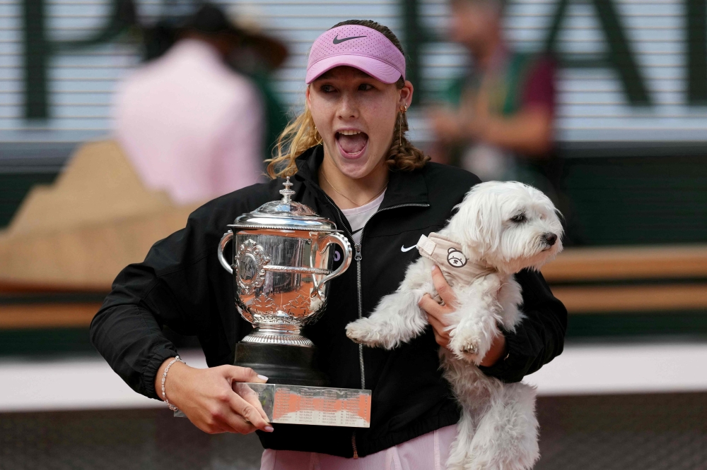 Russia’s Mirra Andreeva poses with the Coupe Suzanne Lenglen and her dog after winning the French Open women’s singles final at Roland-Garros in Paris, June 6, 2026. — AFP pic