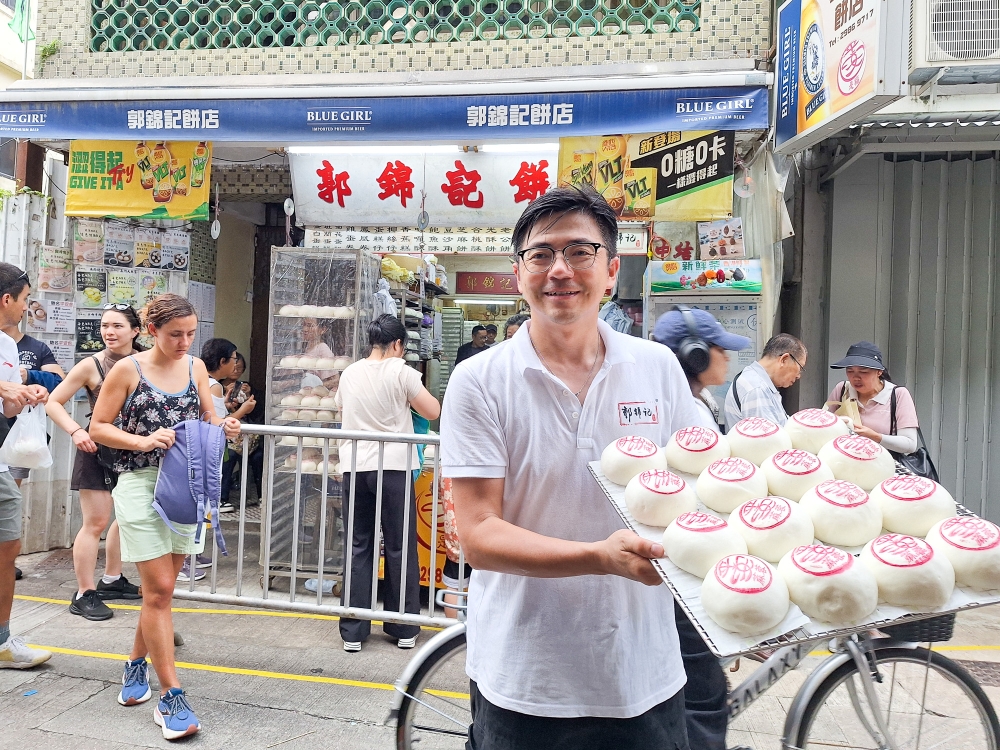 Martin Kwok at Cheung Chau’s 54-year-old Kwok Kam Kee bakery, which he has kept unchanged even after taking over the business in 2017. — Picture by Ida Lim