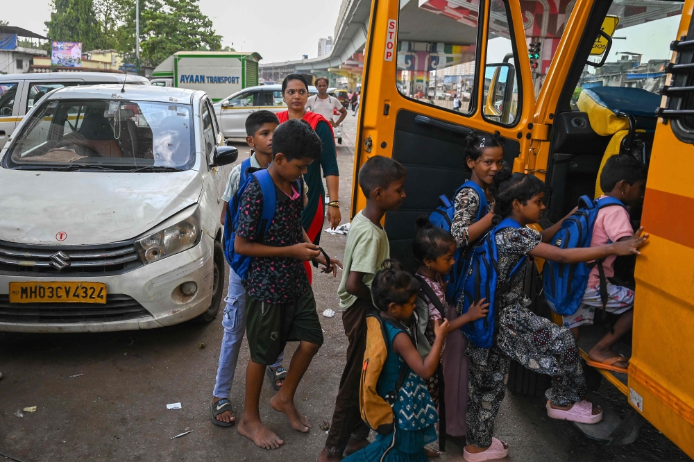 Children board the Signal Shala bus, Mumbai’s traffic signal school on May 25, 2026. — AFP pic
