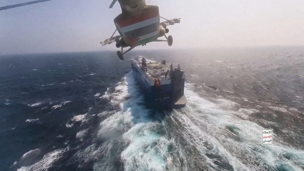 Houthi military helicopter flies over the Galaxy Leader cargo ship in the Red Sea in this photo released November 20, 2023. — Houthi Military Media handout pic via Reuters