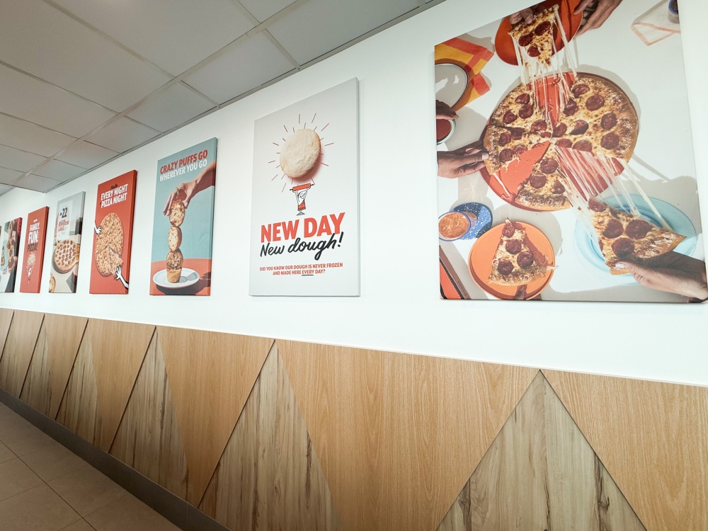 Fun posters line the corridor leading to the restaurant's seating area. — Picture by Lee Khang Yi