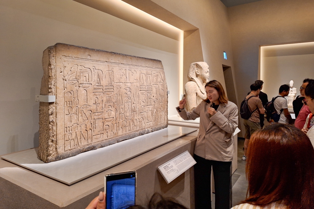 A millenia-old piece of limestone with the ancient Egyptian script hieroglyphics on it is seen here at HKPM. Get a public guided tour ticket if you have the time for it. — Picture by Ida Lim