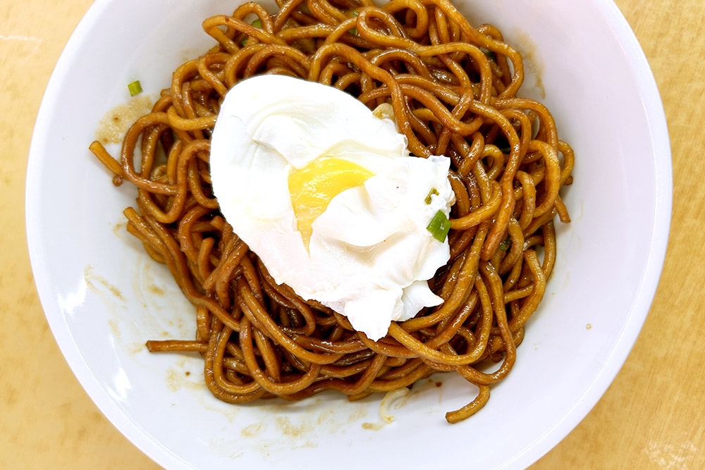 Transfer the poached egg from the soup into the bowl of noodles. — Picture by CK Lim