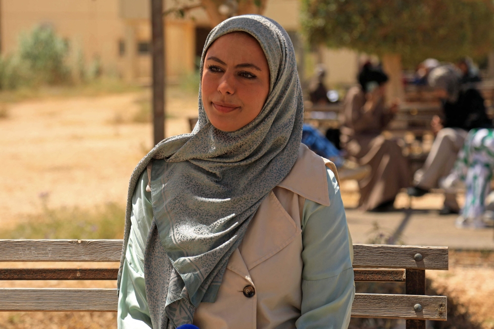 Maryam Alrefadi, a French language graduate poses inside the campus of the University of Benghazi. — AFP pic