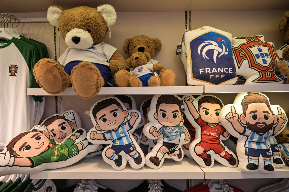 On a weekday at a nearby All Star Partner storefront, shoppers trickled in to browse racks of jerseys and plush bag charms, along with display tables scattered with key chains, pet toys and inflatable neck pillows stored in a silicone horse. — AFP pic 