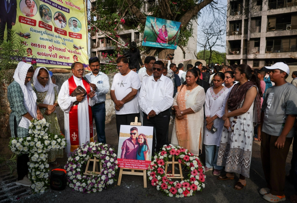 Family members pray at the crash site during the first anniversary of the Air India Boeing 787-8 Dreamliner crash in Ahmedabad June 12, 2026. — Reuters pic 