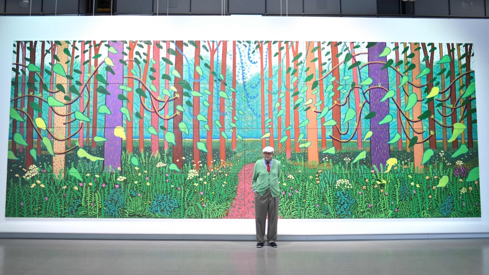 British painter David Hockney poses at the Pompidou Centre in Paris on September 26, 2017 in front of one of his painting ‘The Arrival of Spring in Woldgate, East Yorkshire in 2011’, a work made of an assemblage of various paintings, that he donated to the museum. Hockney, considered one of the most influential and defining figures in contemporary art, whose paintings captured the world in brilliant colour, has died aged 88, his public relations agent announced yesterday. — AFP pic 