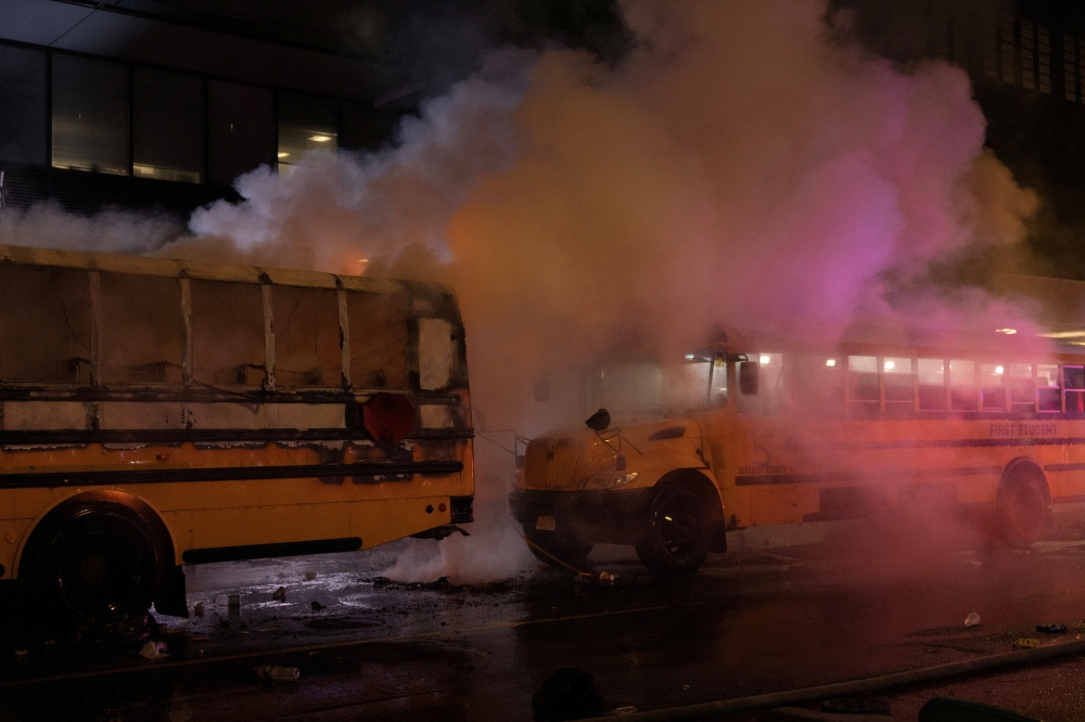 A fire on a shuttle bus, used to transport spectators for 2026 Fifa World Cup, is extinguished outside the Port Authority Bus Terminal in New York, amid celebrations over the New York Knicks’ win over the San Antonio Spurs and World Cup festivities, New York June 14, 2026. — Reuters pic