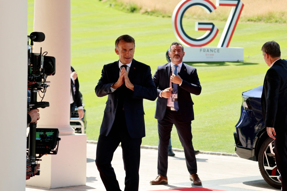 French President Emmanuel Macron arrives at the Hotel Royal ahead of the start of the G7 summit in Evian, France on June 15, 2026. — AFP pic