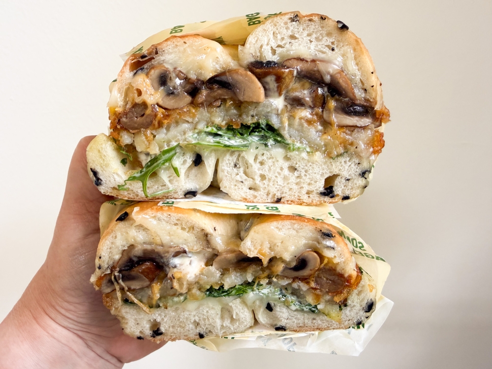 Happy Mushroom will definitely perk up your day with its mushrooms, mozzarella, and rocket, served with creamy aioli and a fluffy black olive bagel. — Picture by Lee Khang Yi