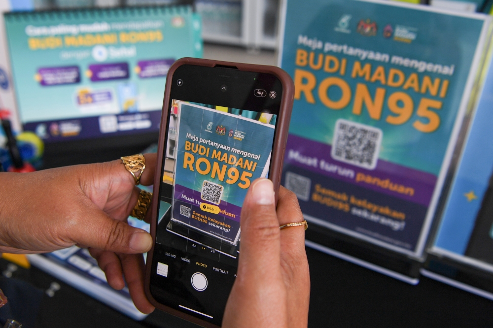 A standee publicises the BUDI95 initiative at a petrol station in Kuala Lumpur on September 25, 2025. — Bernama pic
