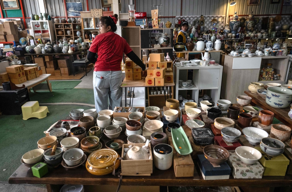 Employees preparing household items for sale at a Japanese second-hand goods warehouse store in Nonthaburi, Thailand. — AFP pic