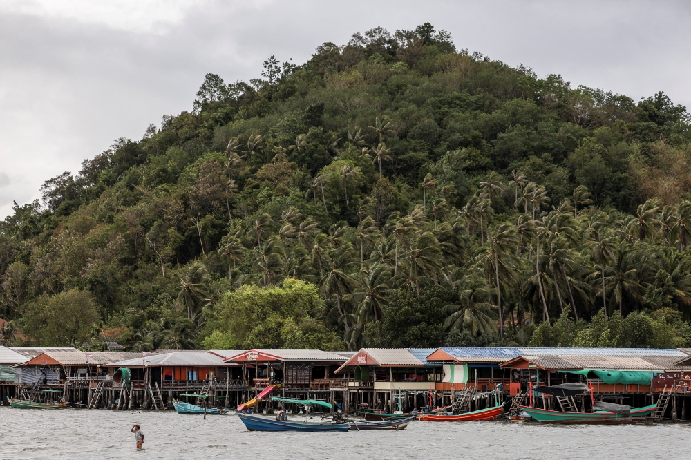 A woman walks toward her boat on Koh Phitak Island, in Chumphon province, near the site of Thailand’s proposed Southern Land Bridge project, May 17, 2026. — Reuters pic