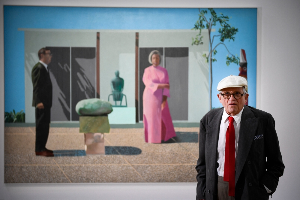 British artist David Hockney poses in front of his painting ‘Fred and Marcia Weisman’ at the Pompidou Centre in Paris, on June 16, 2017. One of his works fetched US$8.5 million (RM36.1 million) at the Art Basel in Switzerland a week after his death on June 11, 2026. — Photo by Martin Bureau/AFP
