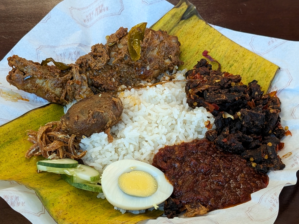 ‘Nasi lemak rendang ayam’ with ‘sambal paru’ and ‘begedil’: breakfast of champions! — Picture by Ethan Lau