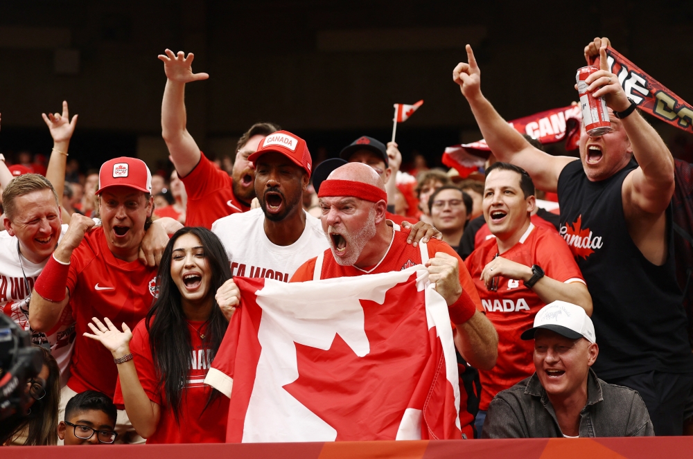 Canada fans celebrate after Jonathan David scored their sixth goal to complete his hat-trick during the Fifa World Cup 2026 Group B match between Canada and Qatar at BC Place, Vancouver June 18, 2026. — Reuters pic