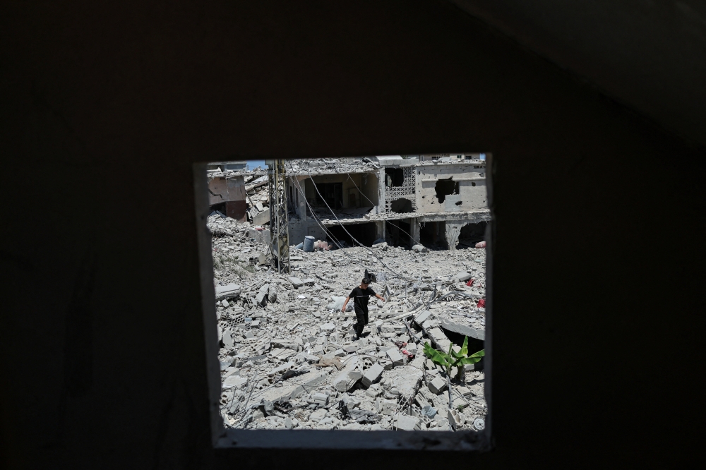 A boy walks among the rubble of a neighborhood completely destroyed by an Israeli airstrike, following the US-Iran deal, in Qlailieh, Tyre district, Lebanon, June 18, 2026. — Reuters pic