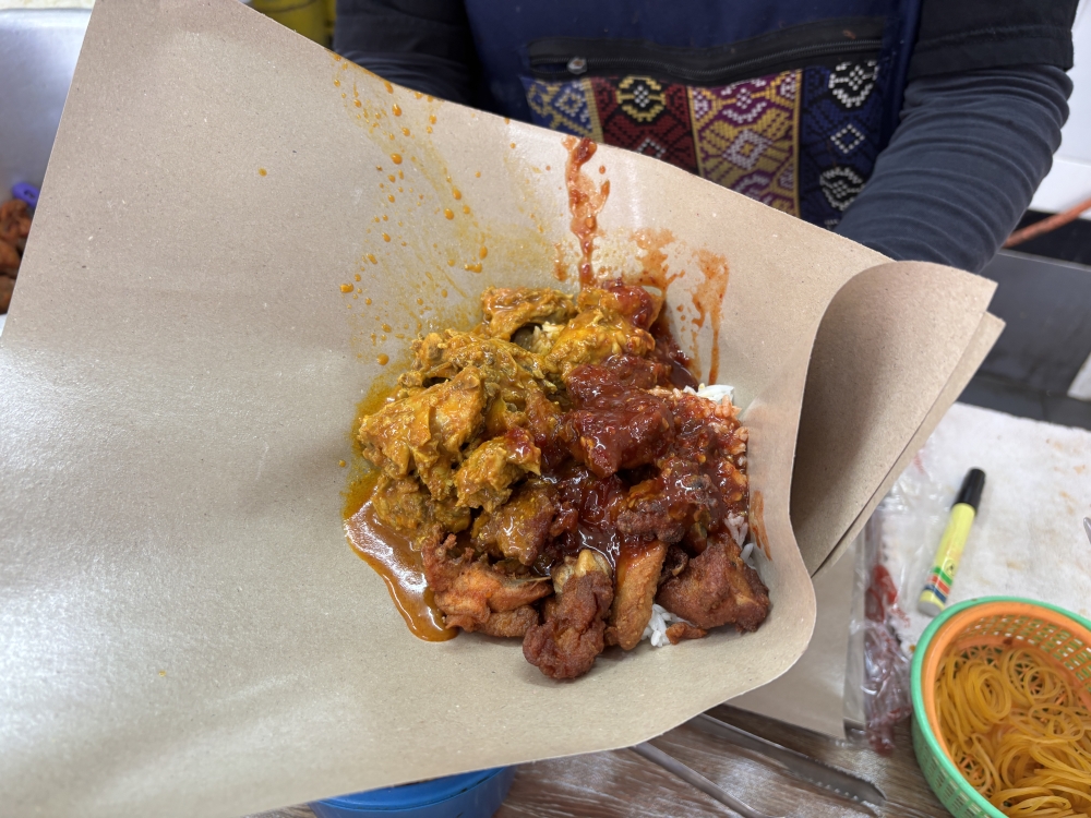 Gerai Kak Meh Nasi Berlauk at the Perak Stadium food court in Ipoh serves a RM6 lunch set comprising rice, curry chicken, fried chicken, ‘sambal belacan’ and curry gravy. — Picture by John Bunyan