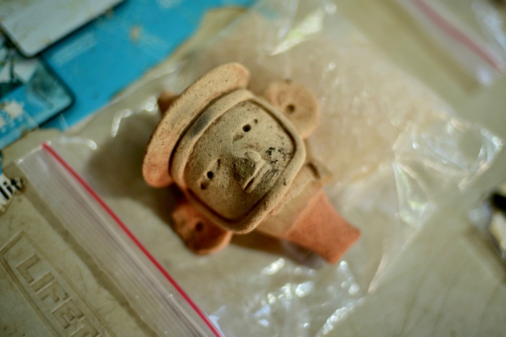 A view shows an anthropomorphic whistle face handled by archaeologists working at an archaeological site in Coatepec, Veracruz, June 18, 2026. — AFP pic