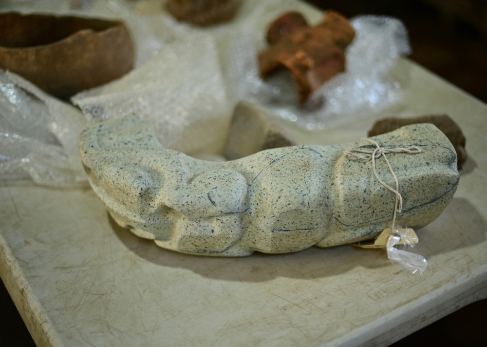 A green stone ‘yoke’ depicting a batrachian is seen among objects found at an archaeological site and undergoing classification and documentation in Coatepec, Veracruz, June 18, 2026. — AFP pic