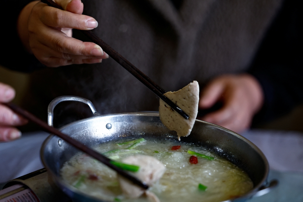 Restaurant owner Song Huailan eats foie gras hotpot during an interview with Reuters in Huoqiu county, Anhui province, April 28, 2026. — Reuters pic