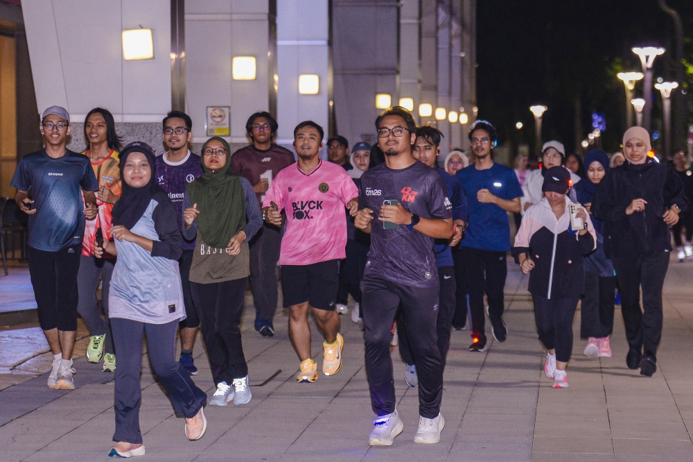 Members of Geng Lukis Malam take part in a run in Putrajaya. — Bernama pic
