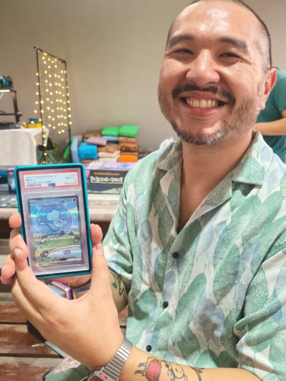 Ian shows his prized Bubble Mew card, which now fetches a value of RM2,000. — The Borneo Post pic