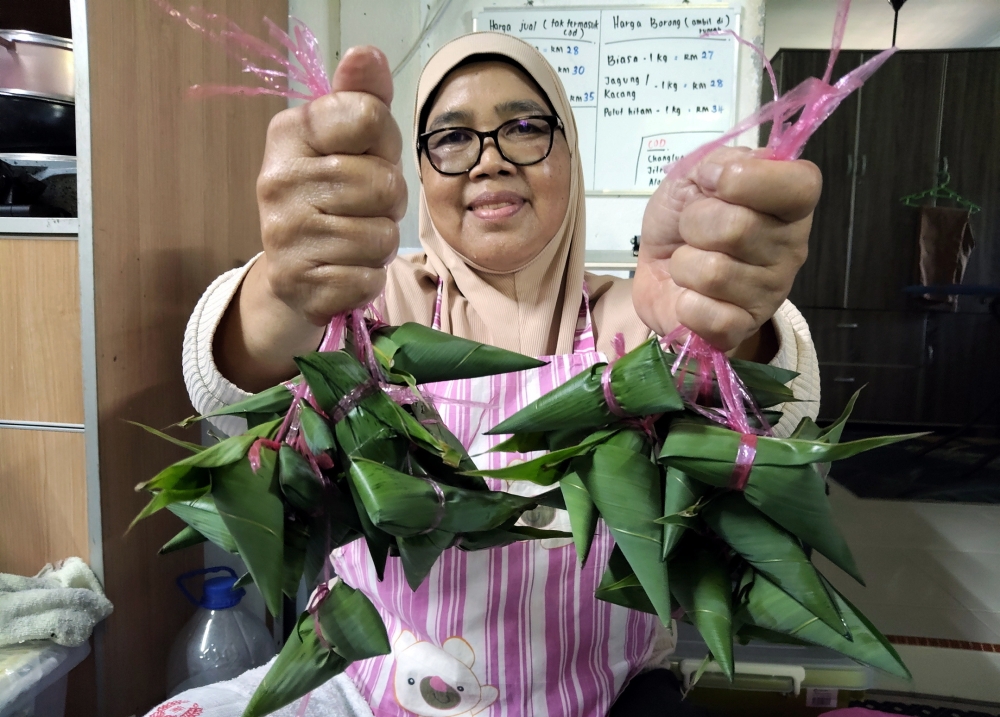 Sarina Saidin shows the bamboo‑leaf ketupat she produces, which has received encouraging demand, at her home in Kampung Wang Perah, Jitra June 22, 2026. — Bernama pic