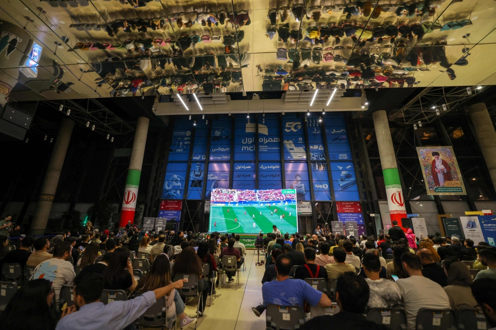 Iranian football fans watch a broadcast of the 2026 World Cup Group G football match between Belgium and Iran in Tehran June 21, 2026. — AFP pic
