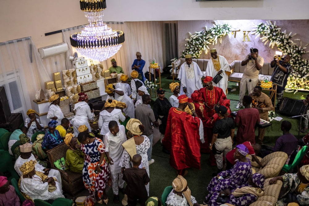 A general view of guests, brides and grooms dancing during the traditional wedding ceremony of twin brothers Taiwo and Kehinde Oguntoye and twin sisters Taiwo and Kehinde Adediran at the RAD Events Hall in Ibadan June 19, 2026. — AFP pic